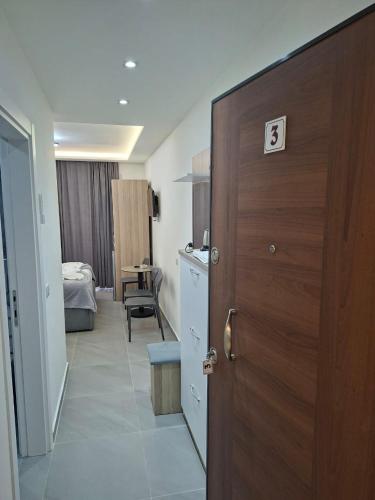 a door to a room with a bedroom and a bed at D&D hotel in Shëngjin