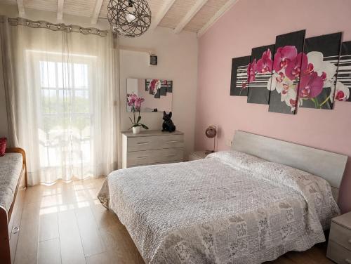 a bedroom with a bed and a dresser and a window at Fattoria Cristina Family Duplex with Pool, Panoramic Terrace & Farm Animals - Bilo Rosa in Castelnuovo Magra
