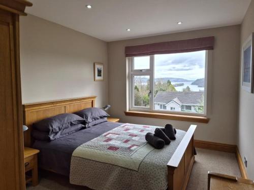 a bedroom with a bed and a large window at Lyndale in Tobermory
