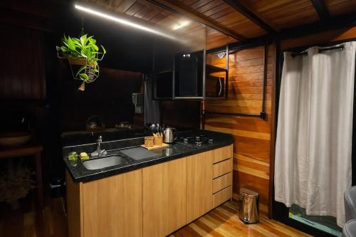 a kitchen with a sink and a counter top at Cabanas Terra Nova in Três Coroas