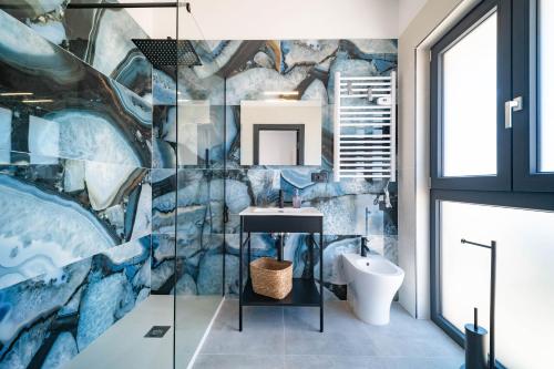 a bathroom with a mural on the wall at La Quintessenza in Monopoli