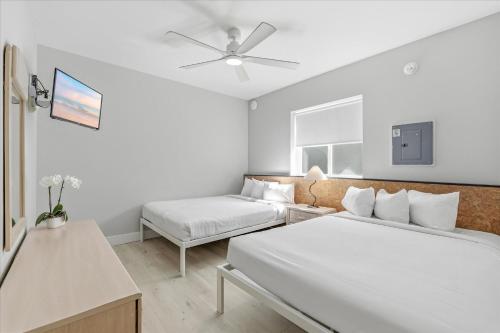 a white room with two beds and a couch at Coliseum Ocean Resort in Wildwood Crest