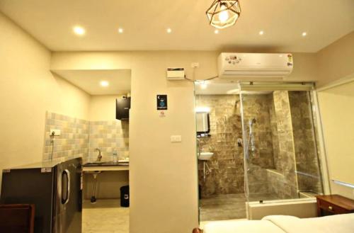 a bathroom with a shower and a sink in a room at Ecovilla luxury in Pondicherry