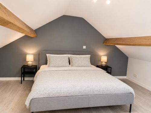 a bedroom with a bed with two lamps on two tables at Albert 18 Brussels-charleroi-airport in Charleroi