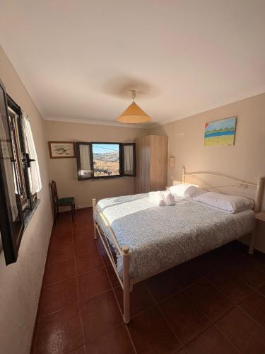 a bedroom with a bed and a window at Casas do Natureza de Coura in Paredes de Coura