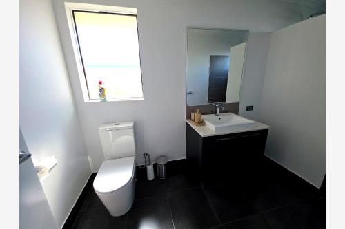 a bathroom with a white toilet and a sink at Baldivis Retreat in Baldivis