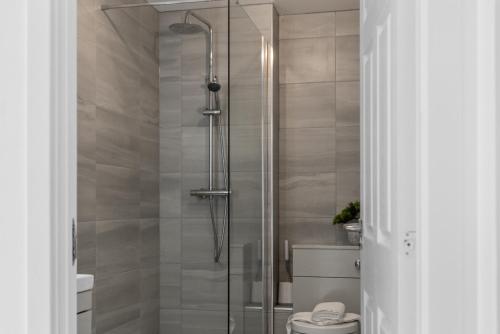 a shower stall in a bathroom with a toilet at Castle View in Stirling