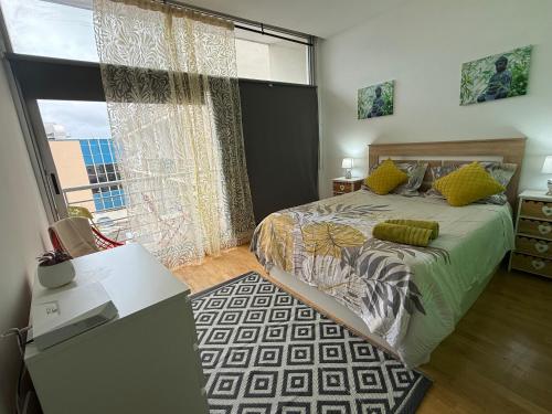 a bedroom with a bed and a large window at Villaverde light & terrace in Madrid