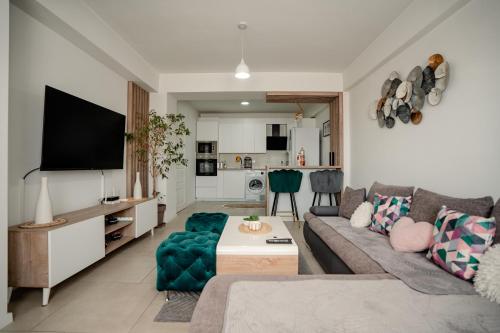 a living room with a couch and a tv at Ohrid Pearl Apartment in Ohrid