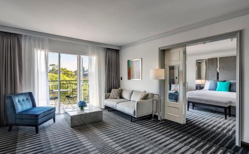 a hotel room with a bed and a couch at InterContinental Sydney Double Bay by IHG in Sydney