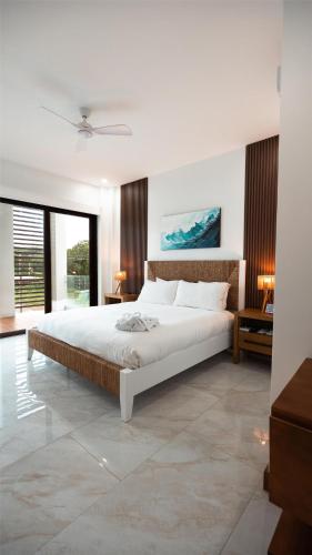 a bedroom with a large bed and a large window at Acqua di Mare Resort in West Bay