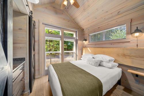 a bedroom with a bed in a wooden cabin at Asheville River Cabins, WorldHotels Backdrop in Arden