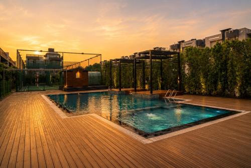 a swimming pool on top of a building at Evaara By The Ganges A Ganga Access Resort & Jungle Safari in Haridwār