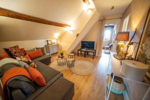 a living room with a couch and a table at LA CORMELLERIE in Saint-Ay