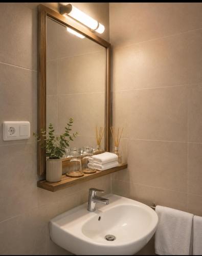 a bathroom with a sink and a mirror at Hostal Bernareggi in Cala Figuera