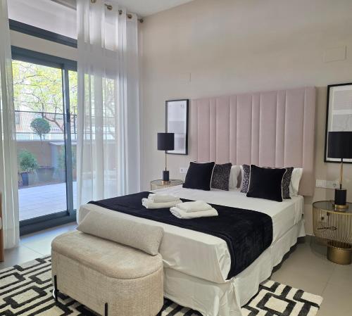 a bedroom with a large bed and a chair at MD Valterna Suites & Pool in Paterna