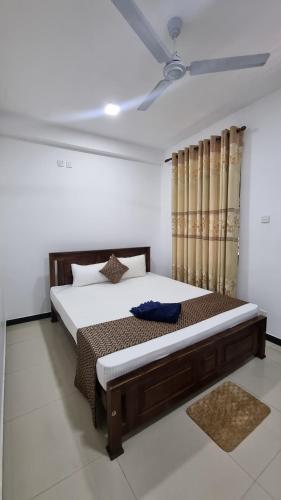 a bedroom with a large bed in a room at Polhena Neptune Resort in Matara