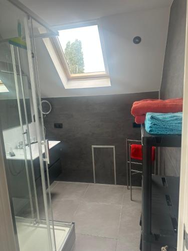 a bathroom with a sink and a skylight at de Zeester in Bredene-aan-Zee