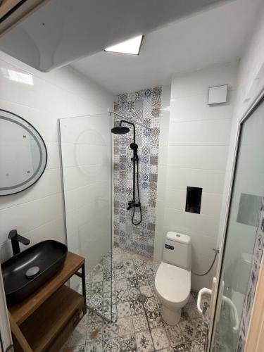 a bathroom with a toilet and a shower at Апартамент Солана - Apartment Solana in Lozenets