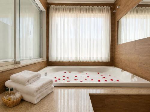 a bathroom with a bath tub with red hearts on it at Hotel Terras da Finlândia in Penedo