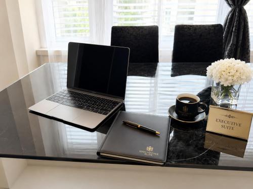 a laptop computer sitting on top of a glass table at Executive Suite-Business Edition in Zurich