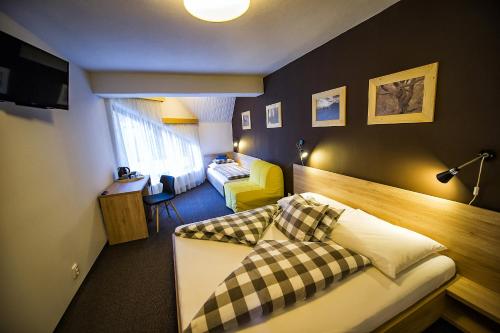 a hotel room with two beds and a bedroom at Penzion Flores in Demanovska Dolina
