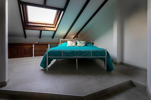 a bedroom with a bed in a room with a window at Villa Buby in Pettenasco