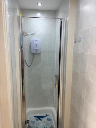 a shower with a glass door in a bathroom at Accommodation by the sea on Sanday in Orkney