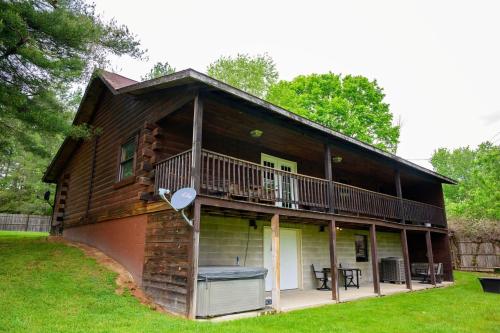 a log cabin with a deck and a balcony at Rustic Way in McArthur