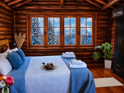 a bedroom with a bed with a plate of food on it at Cabañas San Michele in La Cumbrecita