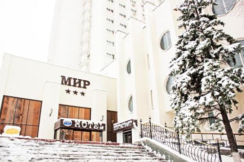a horse drawn carriage in front of a building at Hotel Mir in Kyiv