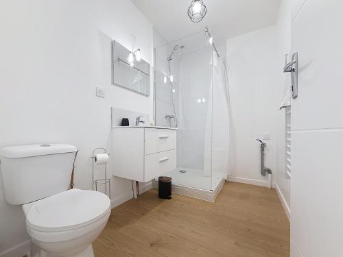 a white bathroom with a toilet and a shower at 8C - L'Urban in Saint-Rambert-dʼAlbon