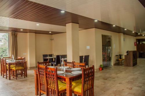 a dining room with a table and chairs at The Kashyap Castle in Gangtok