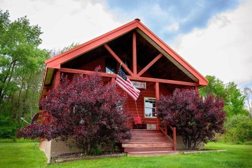 a red house with an american flag on it at Fisherman’s Dream in McArthur