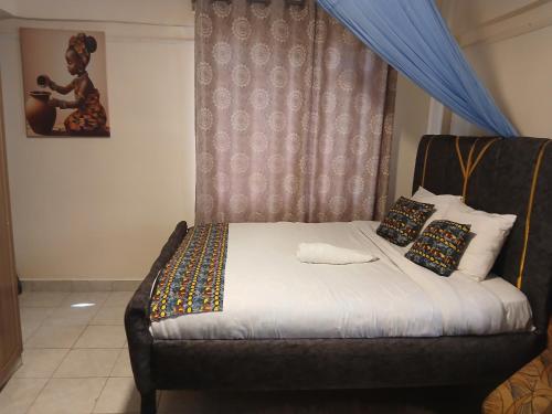 a bedroom with a bed with a blue canopy at Maridadi place in Kakamega