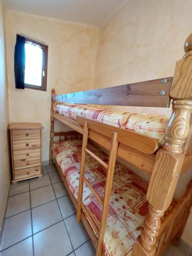 a bedroom with two bunk beds in a room at Le Cyprès - La Fontinelle in Bessas