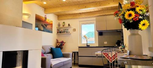 a living room with a couch and a kitchen at Antico Borgo Fonzaso in Fonzaso