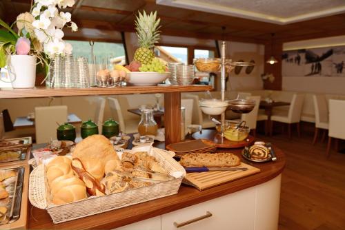 een tafel met veel verschillende soorten brood en gebak bij Apart Residence Rautal ***S in San Vigilio Di Marebbe