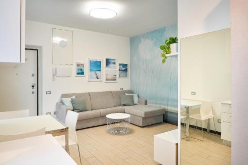 a living room with a couch and a table at Residenza Porta Volta in Milan