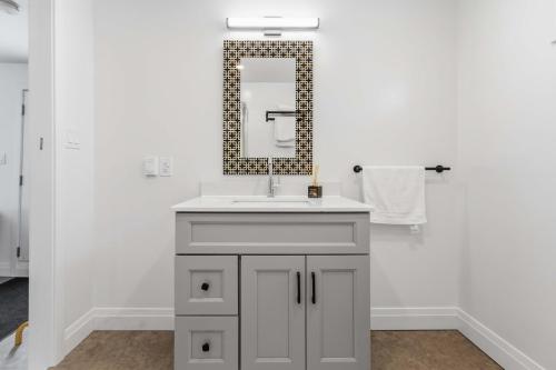 a bathroom with a sink and a mirror at Lakeside Haven suite in Georgina