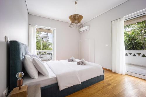 a bedroom with a bed and a large window at City Center Calm Spot in Athens