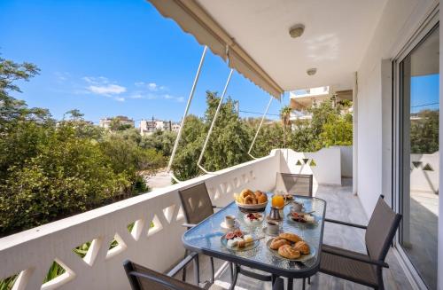 a table on a balcony with food on it at City Center Calm Spot in Athens
