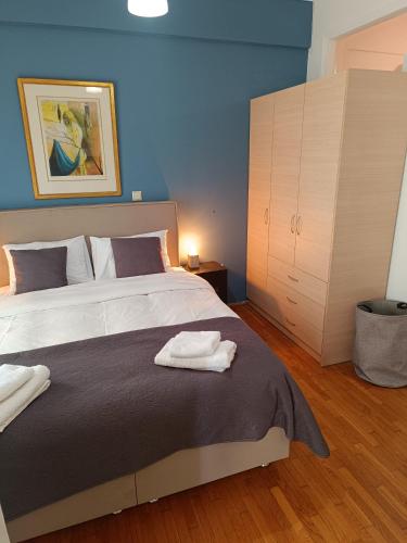 a bedroom with a bed with two towels on it at Thissio Hideaway Suite in Athens