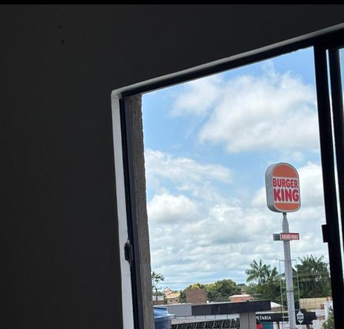 a window view of a burger king sign and a streetking sign at Ótima localização in Imperatriz
