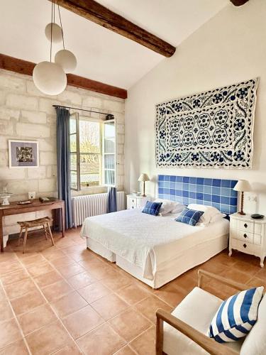 a bedroom with a bed and a desk in a room at DOMAINE DES CLOS Hôtel et appartements- Teritoria in Beaucaire