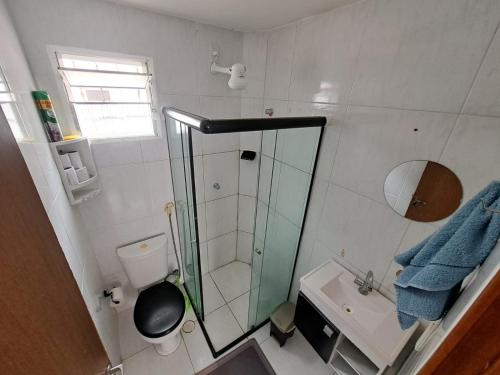 a bathroom with a shower and a toilet and a sink at Apartamento Enseada Beach Residence completo in Cabo de Santo Agostinho