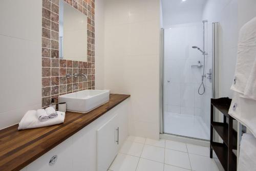 a white bathroom with a sink and a shower at Stucktaymore in Killin