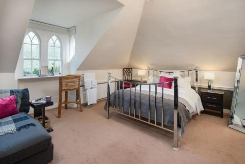 a bedroom with a bed in a room with an attic at Stuckgowan in Arrochar