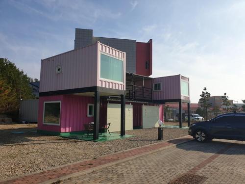 a house with a car parked in front of it at Goseong Sustay Pension in Goseong
