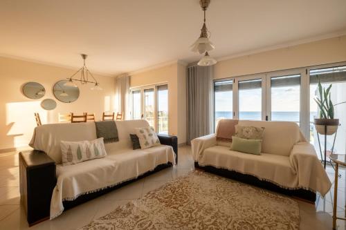 a bedroom with two beds and a couch at Praça da Cultura Residence in Buarcos
